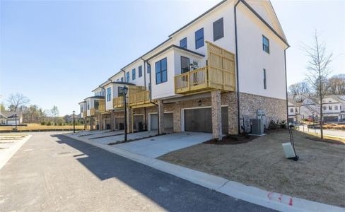 Garages are in the rear of the home. Plenty of room for your cars! Private decks on the back will overlook the wooded area. Photo for representation purposes only, not of actual home but a  previously built TPG home.