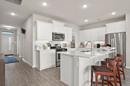 Kitchen in the Masters home plan by Trophy Signature Homes – REPRESENTATIVE PHOTO