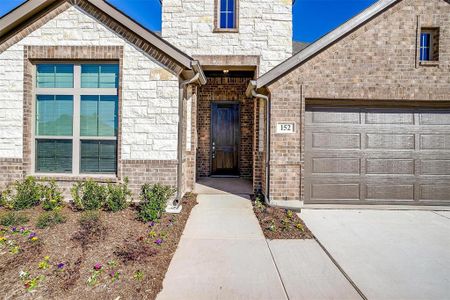 View of exterior entry with a garage