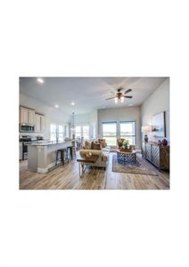 Living room with ceiling fan and light wood-type flooring