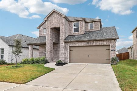 View of front of property featuring a garage and a front yard