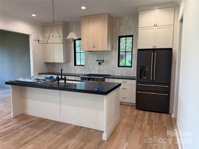 The range hood will be painted the same color as the cabinets.