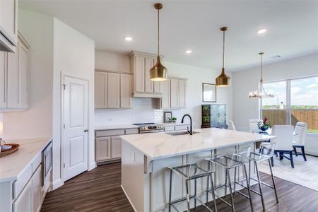 Kitchen with decorative light fixtures, dark wood-type flooring, electric range, and sink