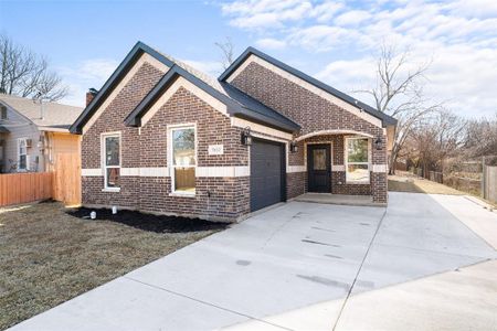 View of front of home with a garage and a front lawn