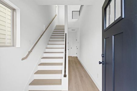 Entryway with clean lines and stairs that ascend to the second floor.