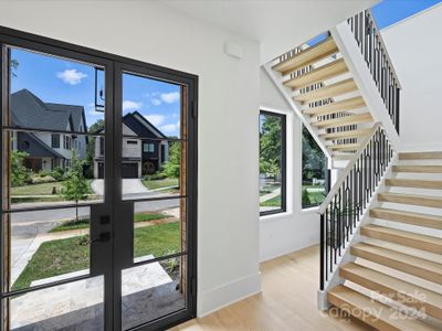 Light and bright entry with custom staircase