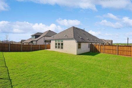 Rear view of house with a yard