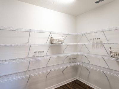 A walk-in pantry provides storage convenience.