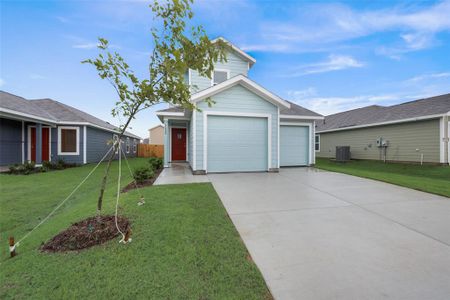 View of front of property featuring a garage and a front yard