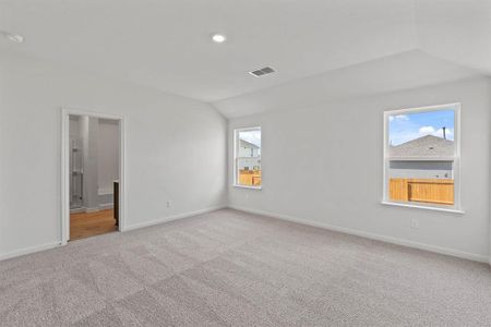 Bedroom featuring carpet flooring and vaulted ceiling