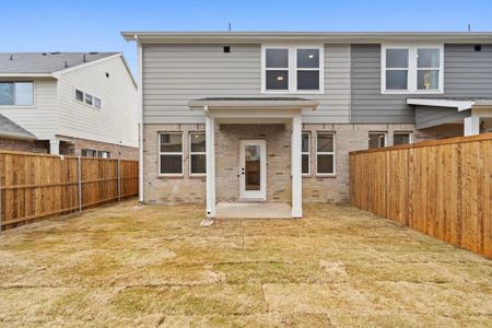 Back of house with a yard and a patio area