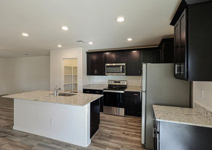 Enjoy stunning granite countertops and designer wood cabinetry in this kitchen.