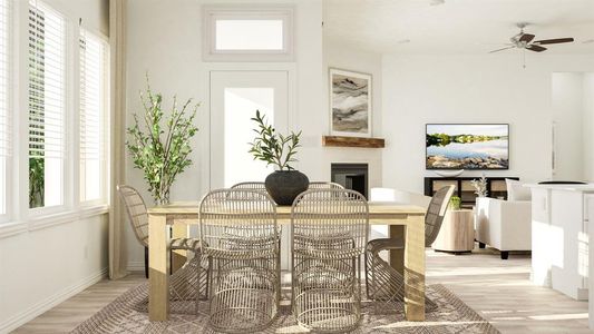 Dining space with ceiling fan and light hardwood / wood-style floors