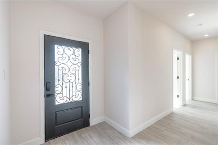 Foyer entrance featuring light hardwood / wood-style floors