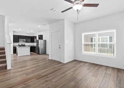 Open layout with a large living room leading into the upgraded kitchen.