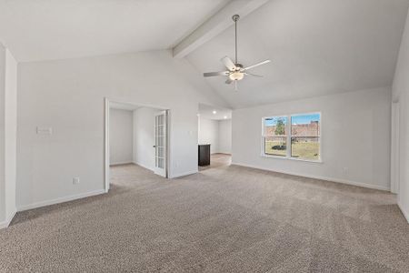 Unfurnished living room with carpet, beam ceiling, ceiling fan, high vaulted ceiling, and baseboards