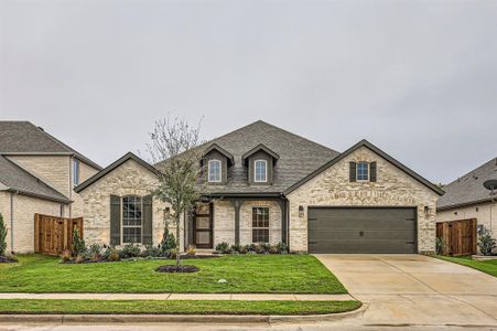 French country style house featuring a front yard and a garage