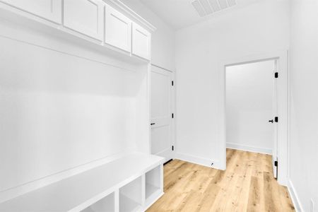 Mudroom with light hardwood / wood-style flooring