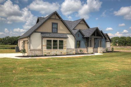 Craftsman-style house featuring a garage, a front yard, and central air condition unit