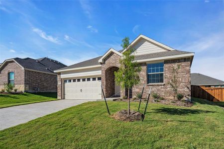 View of front of house with a front lawn and a garage