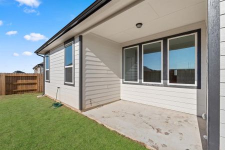 The covered patio is generously sized, providing ample space for various outdoor activities.