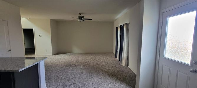 Hallway featuring light carpet