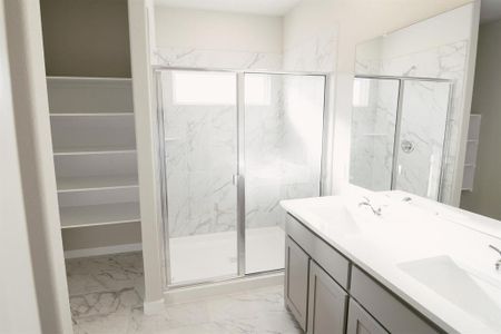 Bathroom featuring vanity and an enclosed shower