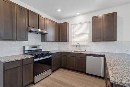 This kitchen is by far any chef’s dream! This spacious kitchen features high ceilings, wood stained cabinets, granite countertops, SS appliances, modern tile backsplash, recessed lighting, extended counter space for breakfast bar, and a walk-in pantry all overlooking your huge family room.