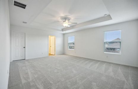 Elegant owner's suite with tray ceiling *real home pictured