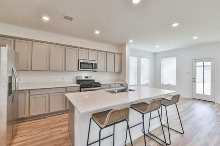 Inviting kitchen area with stainless steel appliances and designer-selected kitchen cabinetry and more than enough storage.