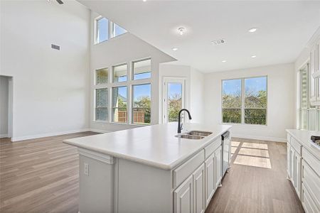 Kitchen featuring a center island with sink, plenty of natural light, and sink