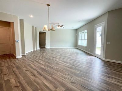 The living room space in the Promenade III  features an expansive, light-filled area with large windows and a versatile layout perfect for both entertaining and everyday living.