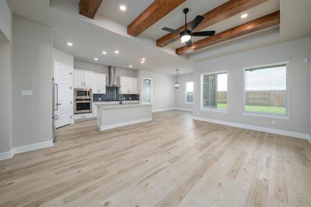 Bathed in natural light from expansive windows or open doorways, the family room exudes an airy and inviting ambiance, enhancing the sense of spaciousness and connection to the outdoors, creating an ideal setting for relaxation and enjoyment.