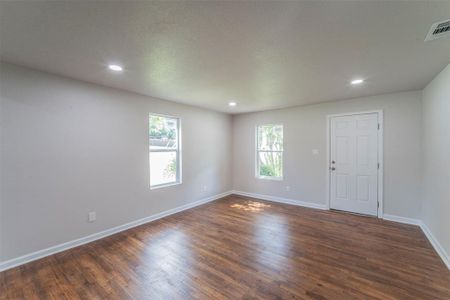 Living room with dark wood-type flooring