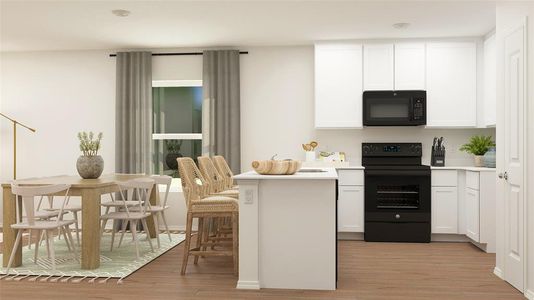 Kitchen with white cabinets, black appliances, and light hardwood / wood-style flooring