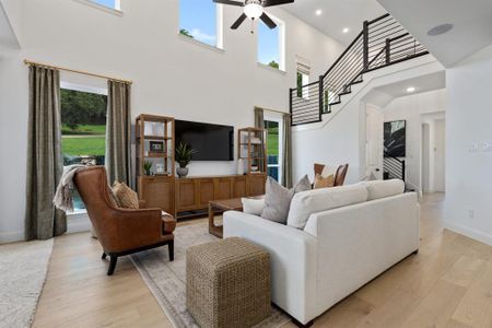 Living room featuring a high ceiling and a wealth of natural light