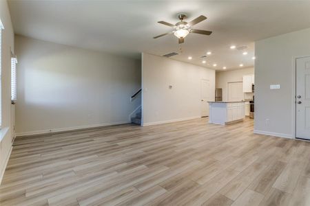 Unfurnished living room with light hardwood / wood-style flooring and ceiling fan