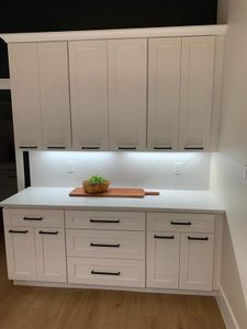 Kitchen with white cabinetry and light wood-type flooring