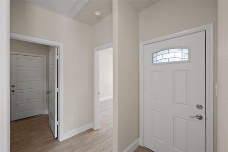 Unfurnished living room with ceiling fan and light hardwood / wood-style flooring