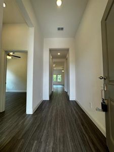 Hall with dark hardwood / wood-style flooring