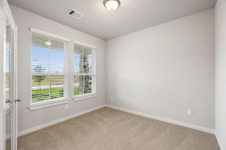 Inviting home office, featuring premium soft carpet that adds a touch of freshness and comfort to the workspace. Sample photo of completed home with similar floor plan. As-built interior colors and selections may vary.