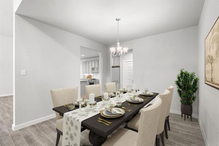 Make memories gathered around the table with your family and friends! This dining spacious room features elegant flooring, custom paint, and adjacent to family room and kitchen for open concept feel. Sample photo of completed home with similar floor plan. As-built interior colors and selections may vary.