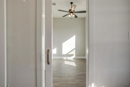 Hall with hardwood / wood-style flooring