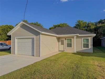 Ranch-style home with a front yard and a garage