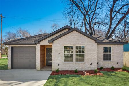 Ranch-style home featuring a garage and a front yard