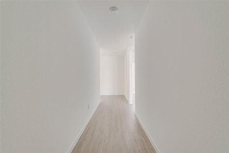 Hallway featuring light wood-type flooring