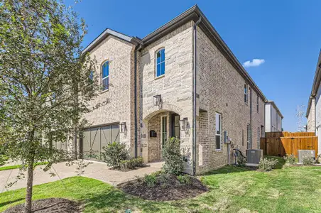 Multi unit property with a front yard, central AC unit, and a garage