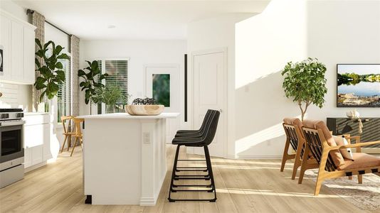 Kitchen featuring light wood-type flooring, stainless steel range oven, a kitchen bar, and white cabinetry