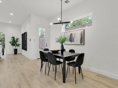 Dining area featuring light hardwood / wood-style floors and an inviting chandelier