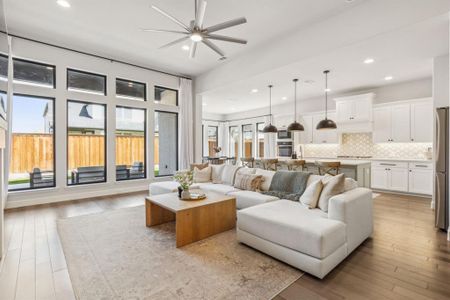 Living room featuring light wood-type flooring and ceiling fan